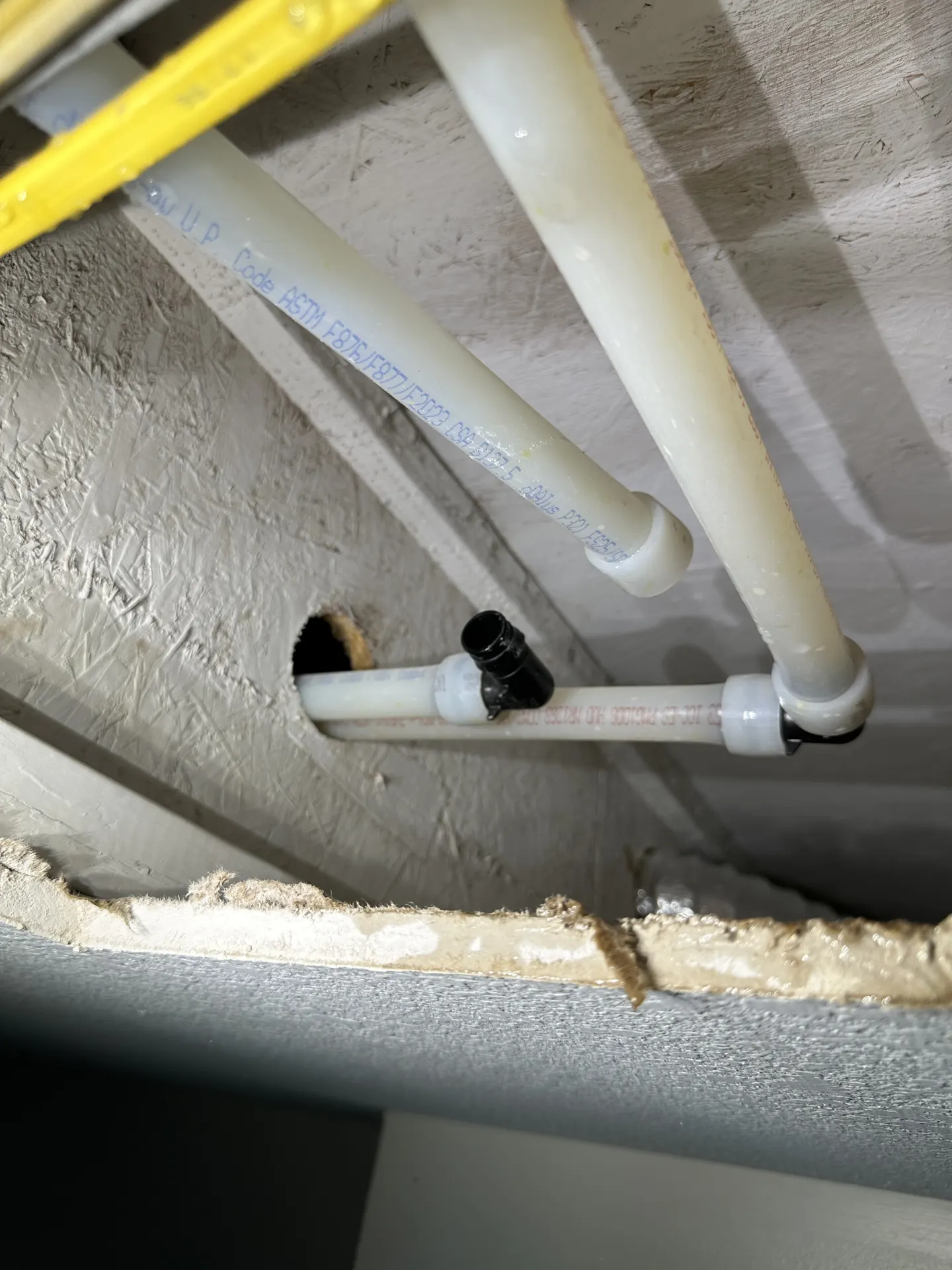 PEX pipe fully separated from a ProPEX elbow fitting in an open ceiling cavity.