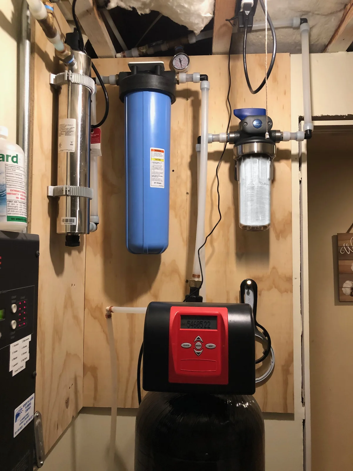Speed King water treatment installation with a red softener control head below wall-mounted filtration equipment